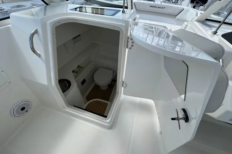 Slide: The Image of Interior view of 2026 World Cat 280 DC-X boat's compact bathroom with toilet and sink. - 5