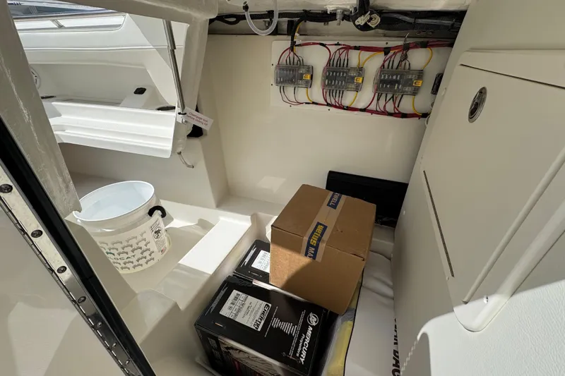 Slide: The Image of Interior of 2026 World Cat 280 DC-X boat with storage and electrical wiring. - 9