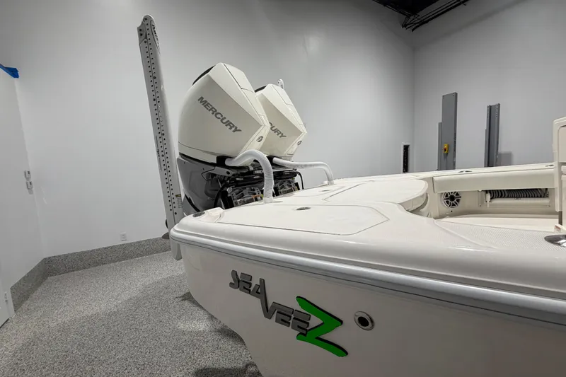 Slide: The Image of 2025 SeaVee 270Z boat with dual Mercury engines in a showroom. - 10