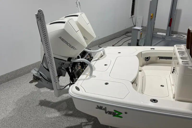 Slide: The Image of 2025 SeaVee 270Z boat with dual Mercury outboard engines in a garage setting. - 11
