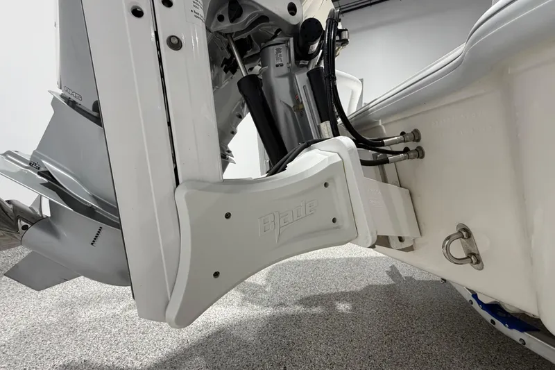 Slide: The Image of 2025 SeaVee 270Z boat engine detail with hydraulic components in a showroom setting. - 13