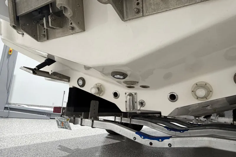 Slide: The Image of 2025 SeaVee 270Z boat hull and trailer detail in a garage setting. - 14