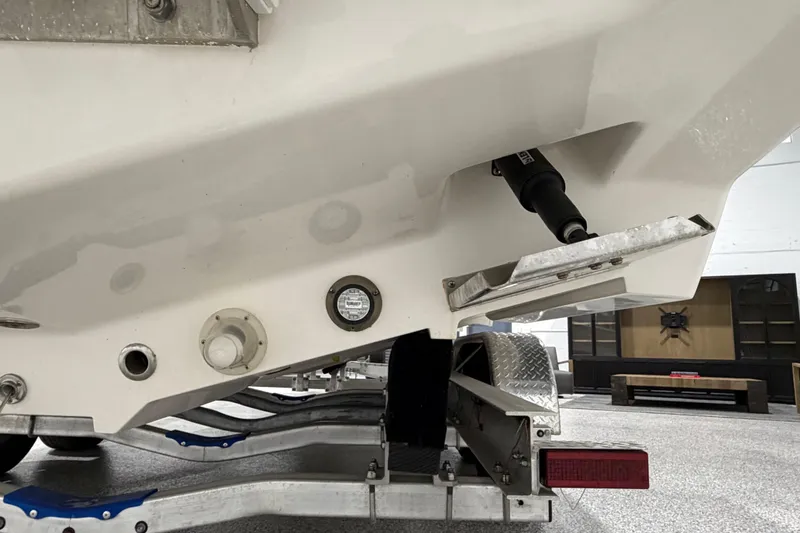 Slide: The Image of 2025 SeaVee 270Z boat hull and trailer detail in a garage setting. - 15