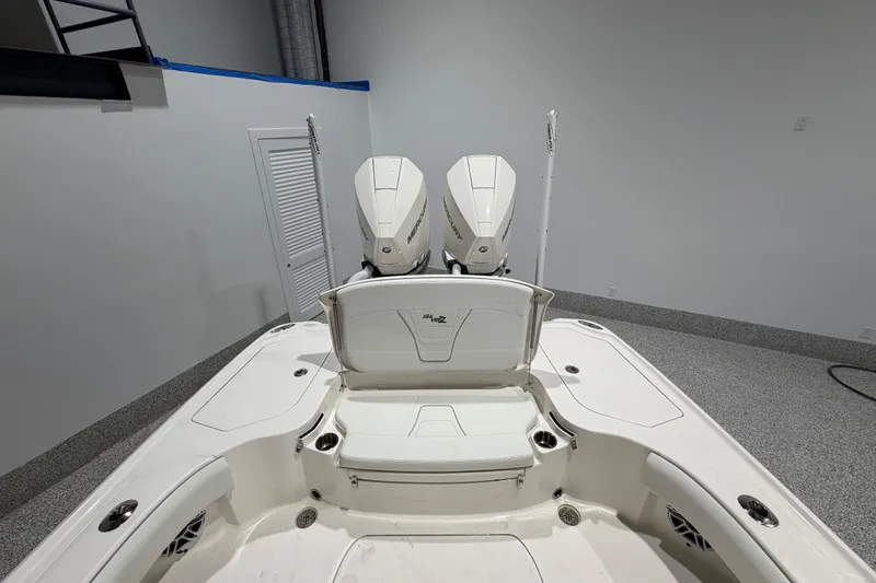 Slide: The Image of 2025 SeaVee 270Z boat with dual outboard engines in a showroom setting. - 16