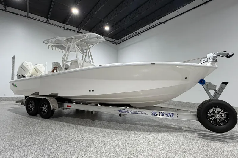 Slide: The Image of 2025 SeaVee 270Z boat on trailer in showroom, featuring dual engines and sleek design. - 2