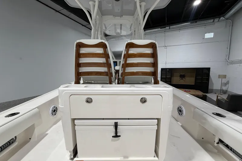 Slide: The Image of 2025 SeaVee 270Z boat interior with dual wooden chairs and storage compartment. - 20