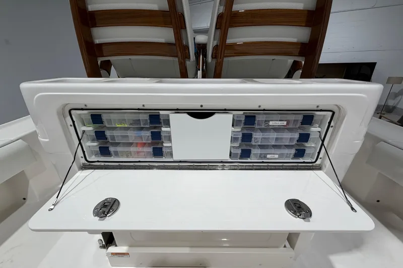 Slide: The Image of 2025 SeaVee 270Z boat storage compartment with organized tackle boxes. - 21
