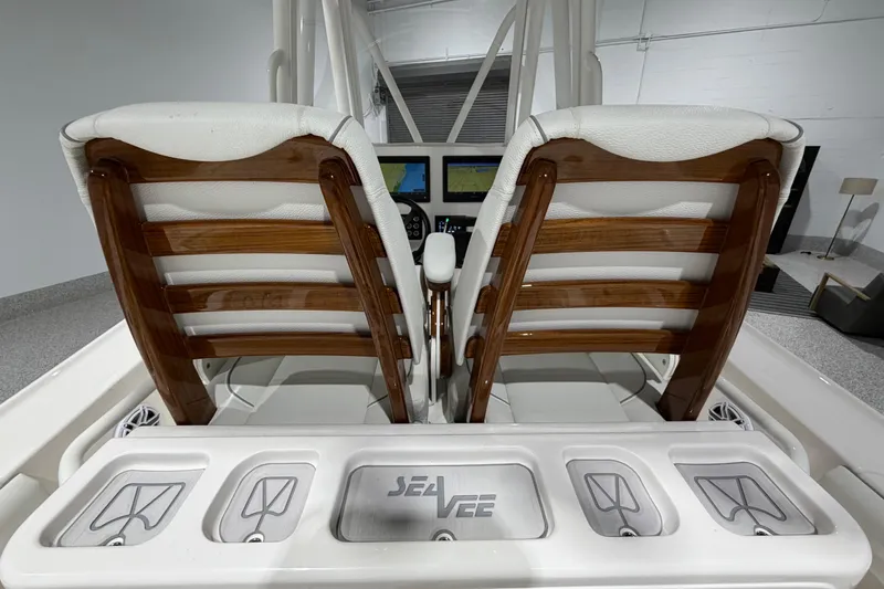 Slide: The Image of 2025 SeaVee 270Z boat interior with wooden seats and control panel. - 22