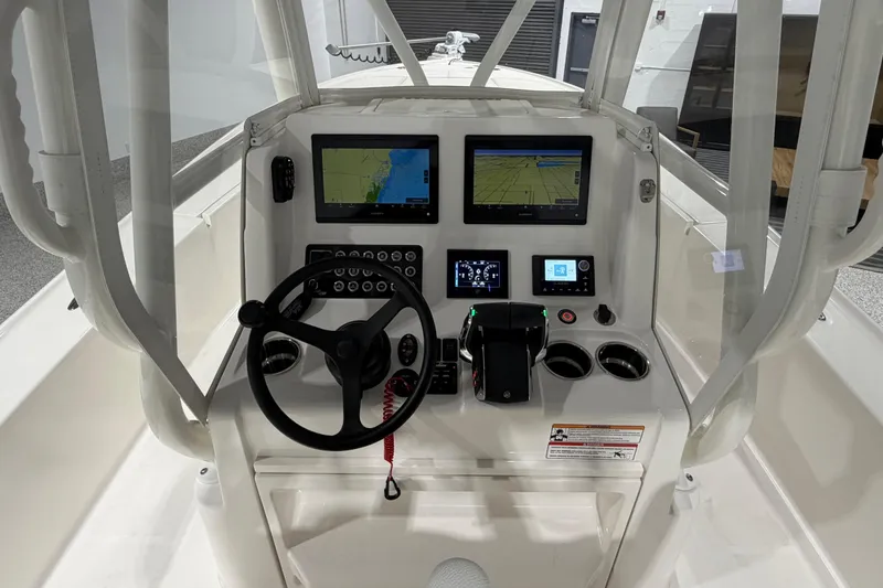 Slide: The Image of 2025 SeaVee 270Z boat dashboard with navigation screens and steering wheel. - 25
