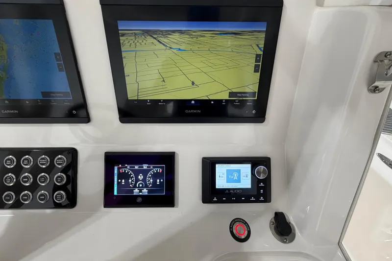 Slide: The Image of Control panel of 2025 SeaVee 270Z boat featuring Garmin navigation displays. - 28