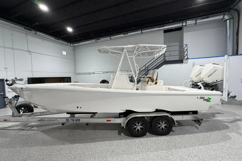 Slide: The Image of 2025 SeaVee 270Z boat on trailer in indoor showroom with dual Mercury engines. - 3