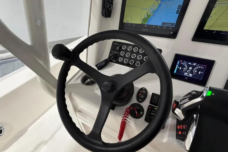 Slide: The Image of Steering console of 2025 SeaVee 270Z boat with navigation screens and controls. - 31