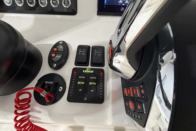 Slide: The Image of Control panel of 2025 SeaVee 270Z boat featuring Lenco trim tab controls. - 32