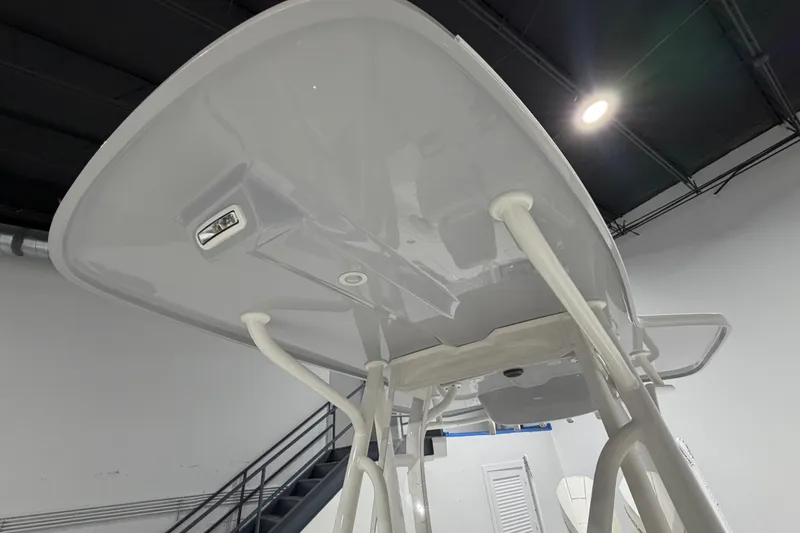 Slide: The Image of 2025 SeaVee 270Z boat's T-top structure in showroom lighting. - 36