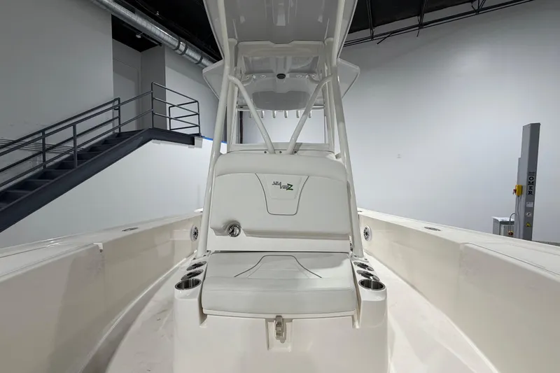 Slide: The Image of 2025 SeaVee 270Z boat interior with seating and cup holders in a showroom setting. - 39