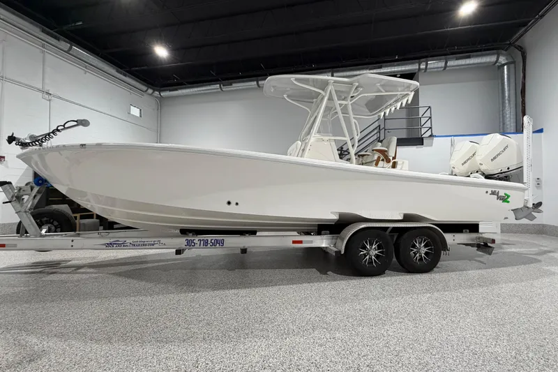 Slide: The Image of 2025 SeaVee 270Z boat on trailer in indoor showroom, side view. - 4