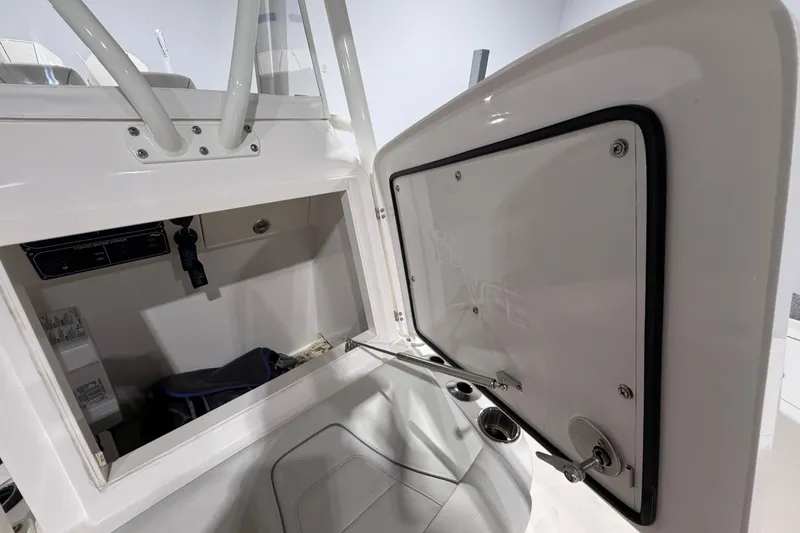 Slide: The Image of 2025 SeaVee 270Z boat interior storage compartment with open hatch and visible equipment. - 40
