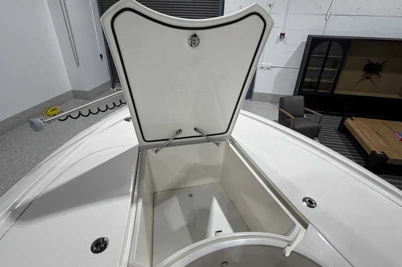 Slide: The Image of 2025 SeaVee 270Z boat storage compartment open in a modern garage setting. - 44