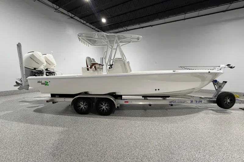 Slide: The Image of 2025 SeaVee 270Z boat on trailer in showroom, featuring dual Mercury engines. - 5