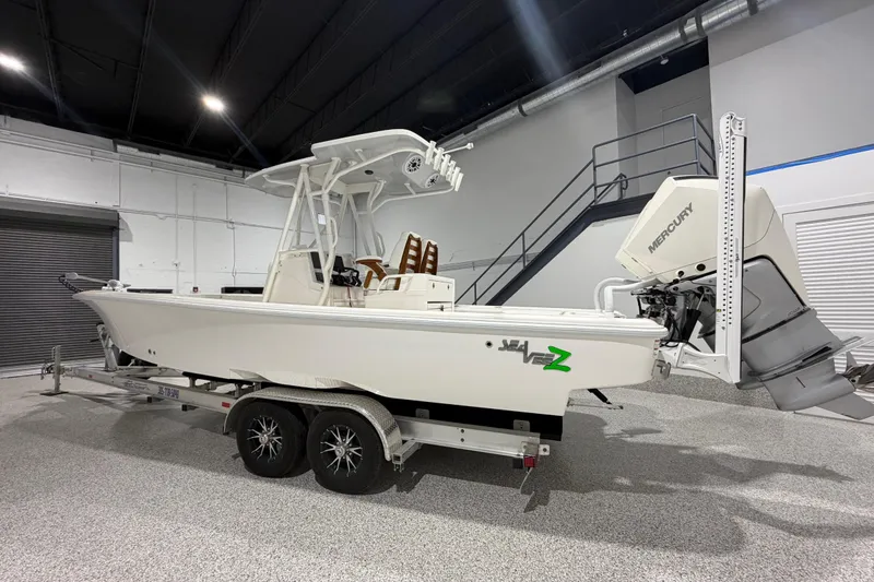 Slide: The Image of 2025 SeaVee 270Z boat on trailer in indoor showroom with Mercury engine. - 6