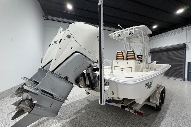 Slide: The Image of 2025 SeaVee 270Z boat with powerful outboard motor in a showroom setting. - 8