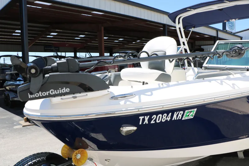Slide: The Image of 2023 Chaparral 21 SSi Ski & Fish boat with MotorGuide trolling motor in a marina. - 13
