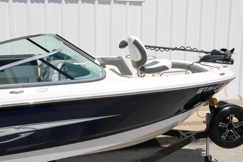 Slide: The Image of 2023 Chaparral 21 SSi Ski & Fish boat on trailer, side view. - 18