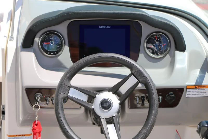 Slide: The Image of 2023 Chaparral 21 SSi Ski & Fish dashboard with steering wheel and gauges. - 22