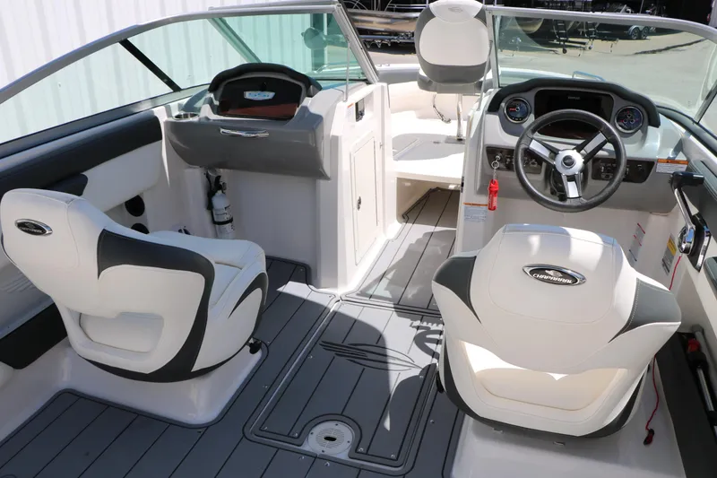 Slide: The Image of 2023 Chaparral 21 SSi Ski & Fish boat interior with steering wheel and seating. - 23