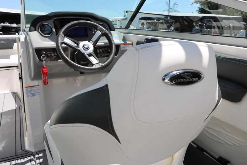 Slide: The Image of 2023 Chaparral 21 SSi Ski & Fish boat interior with steering wheel and branded seat. - 49