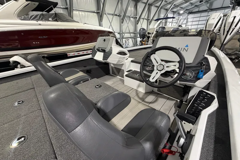 Slide: The Image of 2020 Vexus AVX 2080 boat interior with steering wheel and seating in a storage facility. - 15