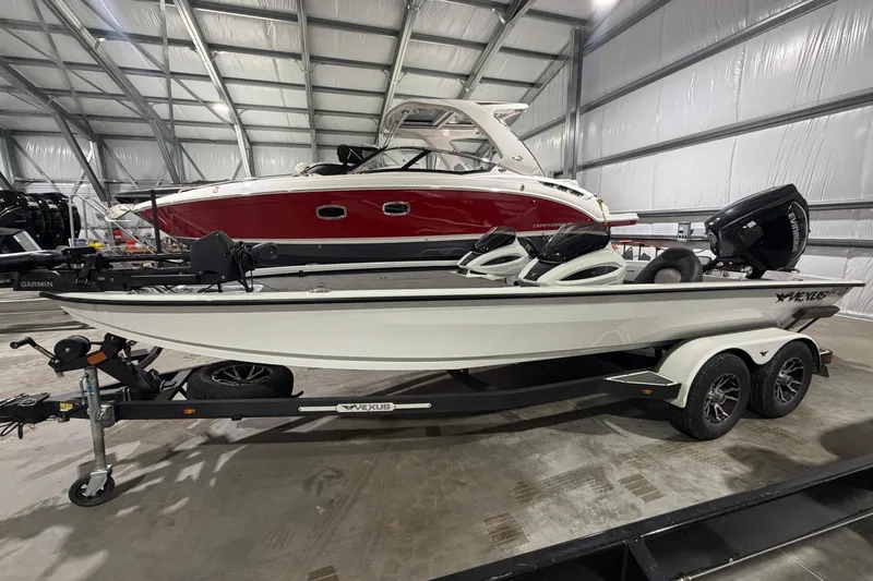 Slide: The Image of 2020 Vexus AVX 2080 boat in storage, featuring sleek design and dual motors. - 3