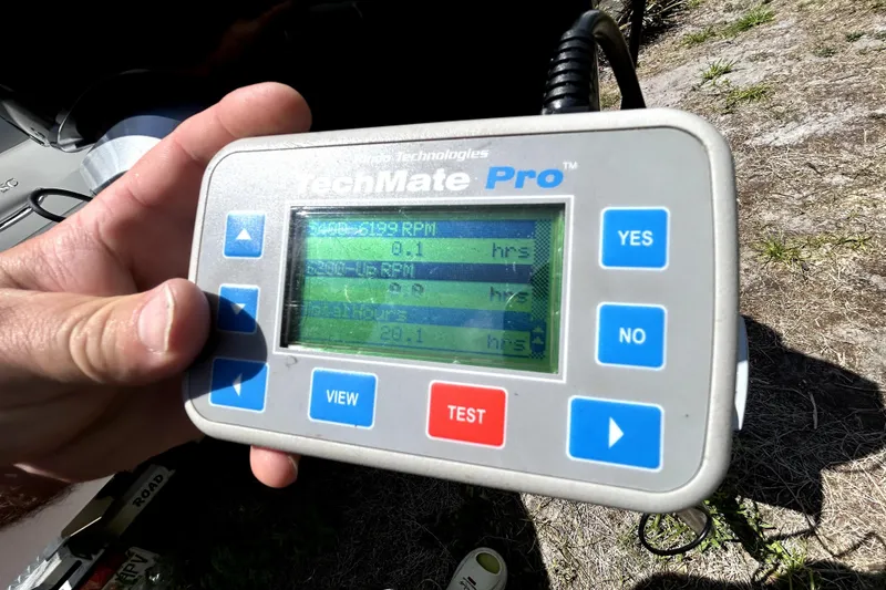 Slide: The Image of Hand holding TechMate Pro diagnostic tool displaying engine data for 2020 Cobalt 23SC. - 103