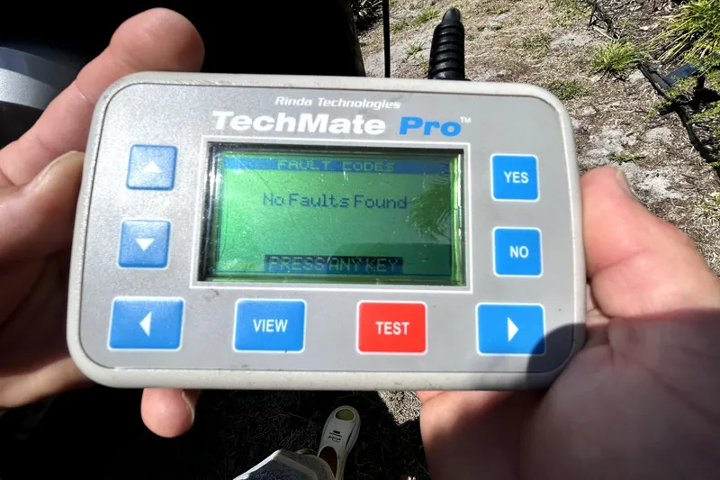 Slide: The Image of Hand holding TechMate Pro diagnostic tool displaying "No Faults Found" message. - 104