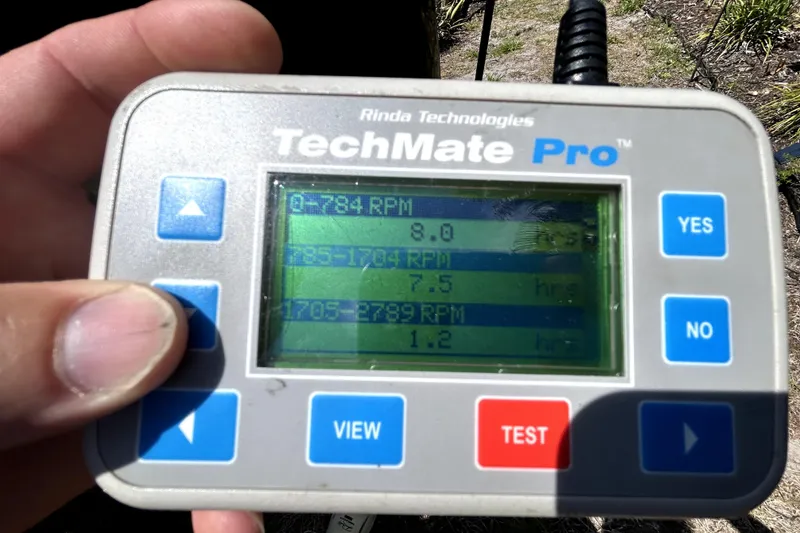 Slide: The Image of Hand holding a Rinda Technologies TechMate Pro diagnostic tool displaying RPM data. - 107
