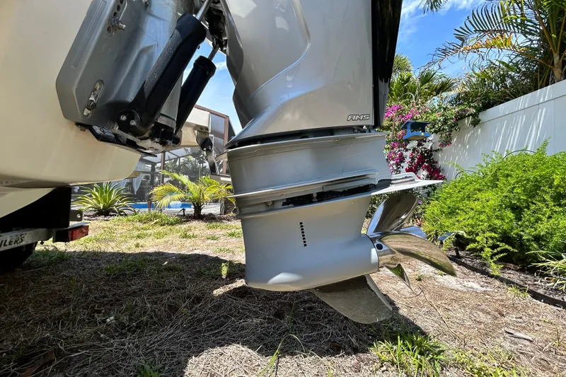 Slide: The Image of Outboard motor of a 2020 Cobalt 23SC boat, surrounded by lush greenery. - 11