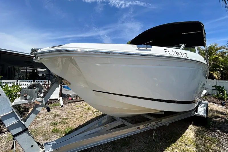 Slide: The Image of 2020 Cobalt 23SC boat on trailer under clear blue sky. - 14