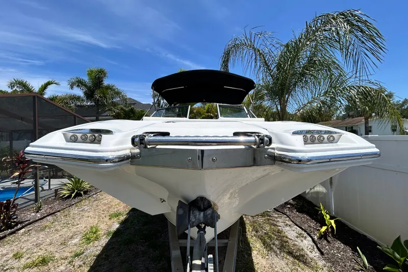 Slide: The Image of 2020 Cobalt 23SC boat on trailer, surrounded by palm trees under a clear blue sky. - 15
