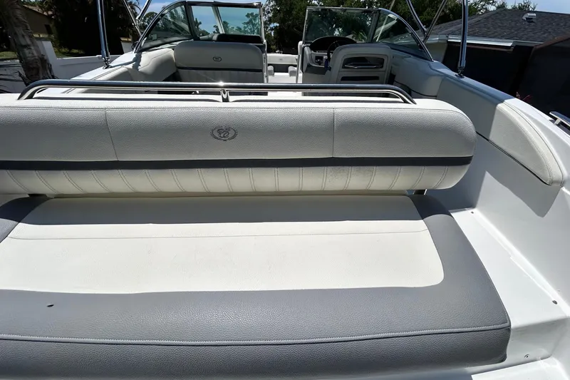 Slide: The Image of 2020 Cobalt 23SC boat interior with white and gray seating, showcasing luxury design. - 20