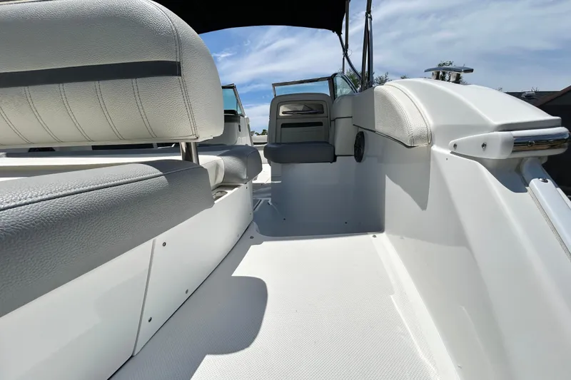 Slide: The Image of 2020 Cobalt 23SC boat interior with white seating and open deck. - 21