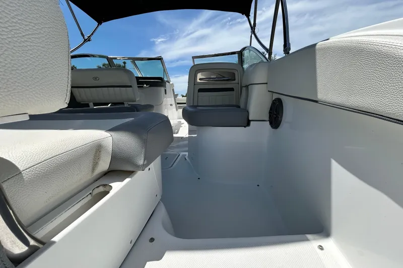 Slide: The Image of Interior view of a 2020 Cobalt 23SC boat with white and gray seating. - 22