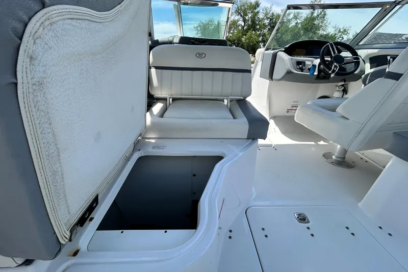 Slide: The Image of 2020 Cobalt 23SC boat interior with open storage compartment and seating. - 27