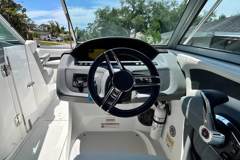 Slide: The Image of 2020 Cobalt 23SC boat cockpit with steering wheel and control panel. - 38