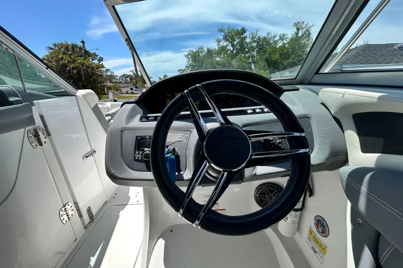Slide: The Image of 2020 Cobalt 23SC boat cockpit with steering wheel and dashboard controls. - 39