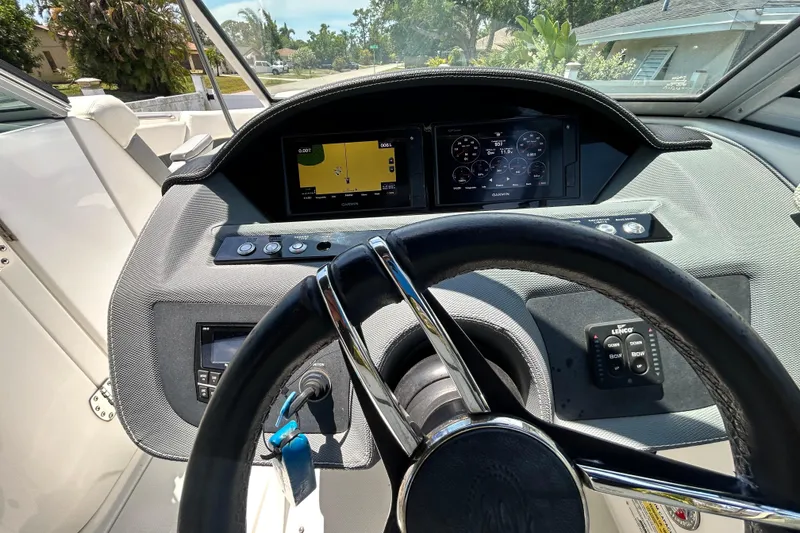Slide: The Image of Dashboard of a 2020 Cobalt 23SC boat with steering wheel and digital displays. - 40