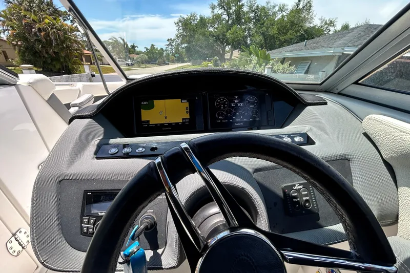Slide: The Image of 2020 Cobalt 23SC boat dashboard with steering wheel and navigation display. - 41