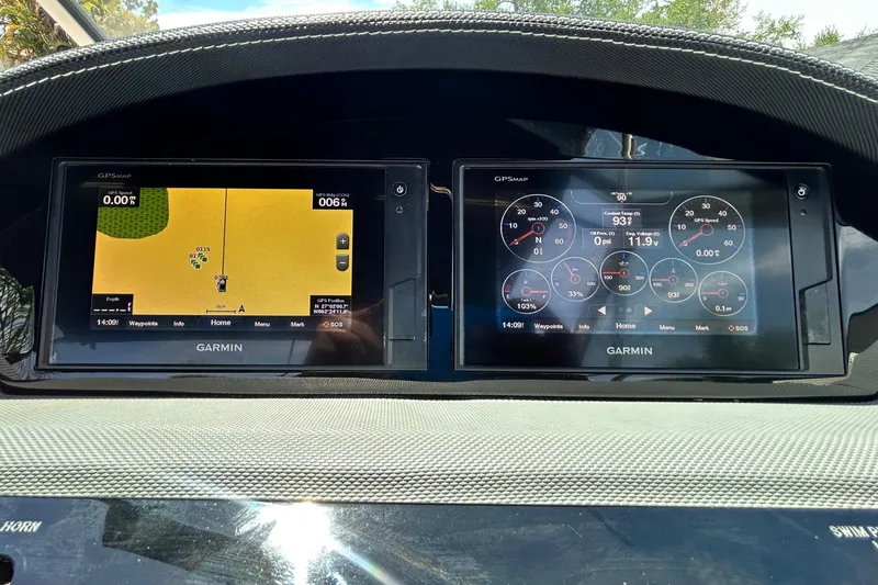Slide: The Image of Dashboard of a 2020 Cobalt 23SC boat featuring dual Garmin displays. - 42