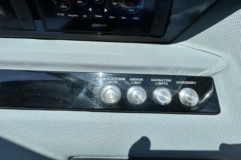 Slide: The Image of Dashboard controls of a 2020 Cobalt 23SC boat with Garmin display. - 45