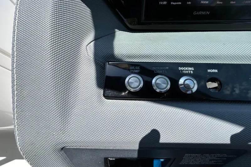 Slide: The Image of Control panel of a 2020 Cobalt 23SC boat with bilge pump and light switches. - 46