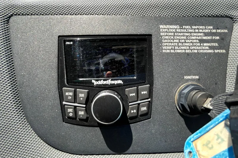 Slide: The Image of Control panel of a 2020 Cobalt 23SC boat featuring a Rockford Fosgate audio system. - 47